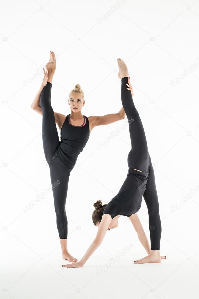 Two girls stretch