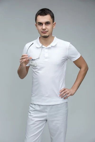 Doctor with binocular loupes — Stock Photo, Image