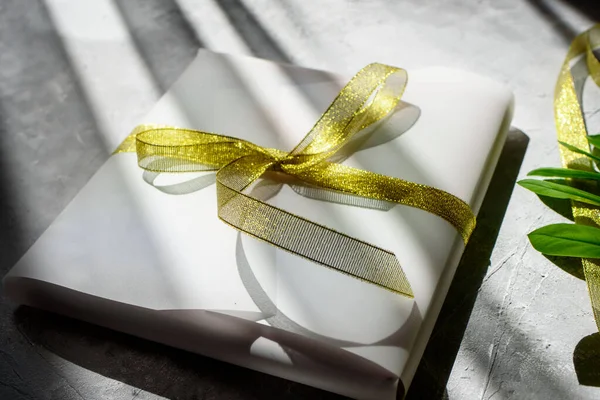 Pakowanie Prezentu Piękny Biały Papier Złotą Wstążkę Szpilki Zielonych Roślin — Zdjęcie stockowe