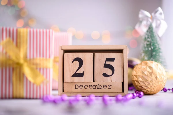 New Year\'s content, Christmas tree gold toys, a small Christmas tree, lights, wood eco cubes with the figure on December 25. Merry Christmas and New Year