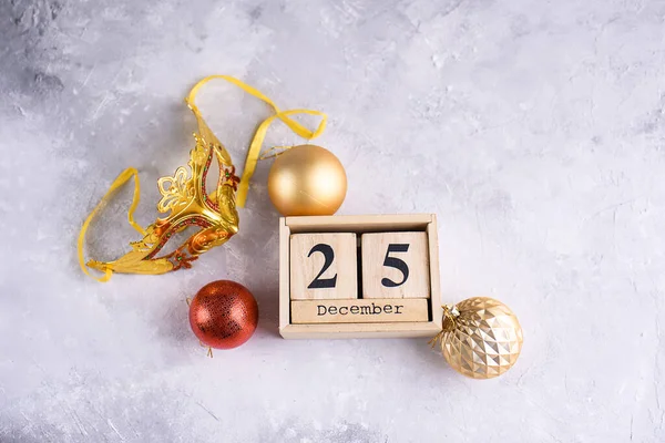 New Year\'s content, Christmas tree gold toys, a small Christmas tree, lights, wood eco cubes with the figure on December 25. Merry Christmas and New Year