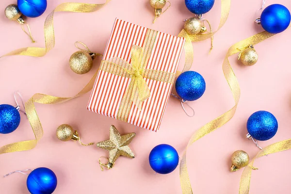 New Year\'s content with sprigs ate, gold toys for the Christmas tree. gift decorated with gold ribbon, the symbol of the new year 2021. Flat lay