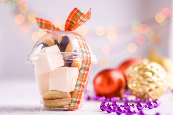サテンリボン付きの箱と新年とクリスマスのためのおいしい御馳走 光の背景に新年のデザート メリークリスマス — ストック写真