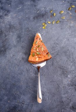 Limon aromalı balkabağı turtası, kabak tohumları, tarçın, kokulu baharatlar ve karanlık bir arka planda baharatlar. Sağlıklı ve lezzetli yemekler.