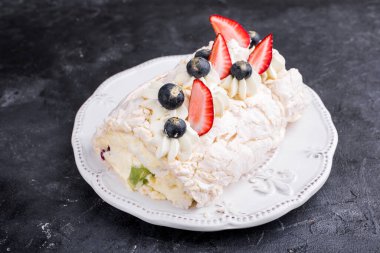 Taze böğürtlen ve meyveli Mereng keki. Çilek, kivi, böğürtlen. Beyaz çatal bıçaklı protein tatlısı. Yemek fotoğrafı.