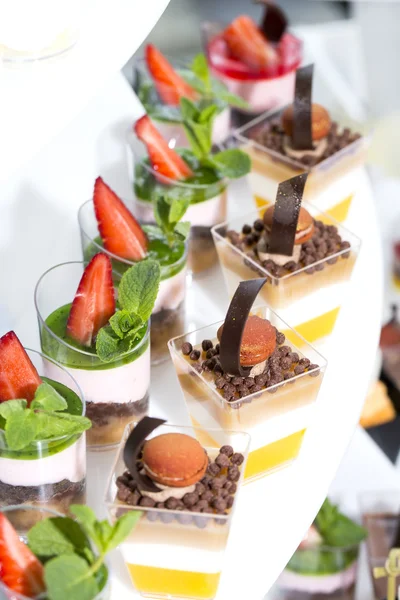 Mini canapes in plastic cups decorated — Stock Photo, Image