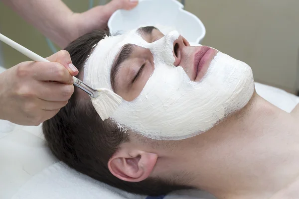 Man in the mask cosmetic procedure — Stock Photo, Image