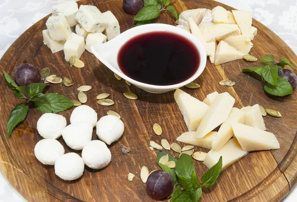 Cheese plate with a large decorated — Stock Photo, Image