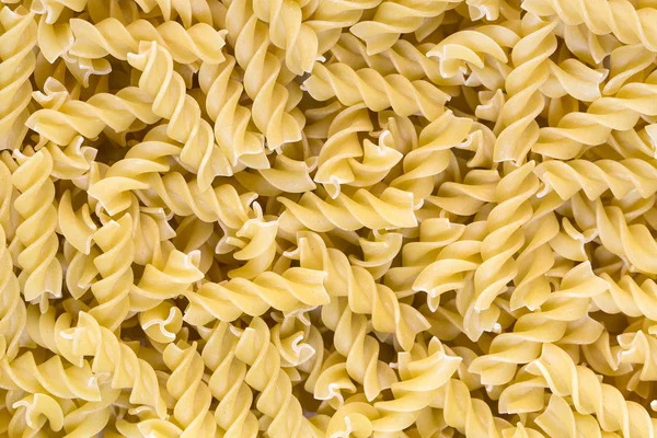 Rå pasta bakgrund på nära håll — Stockfoto