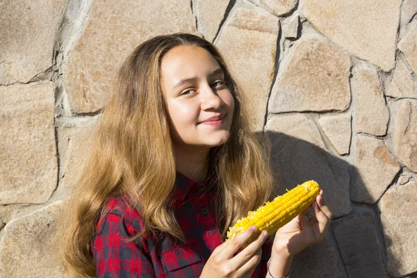 Дівчина їсть солодку кукурудзу — стокове фото