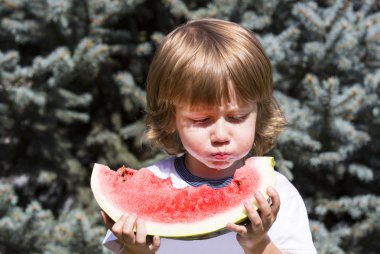 boy eating watermelon