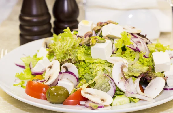 Greek salad on a white plate — Stock Photo, Image