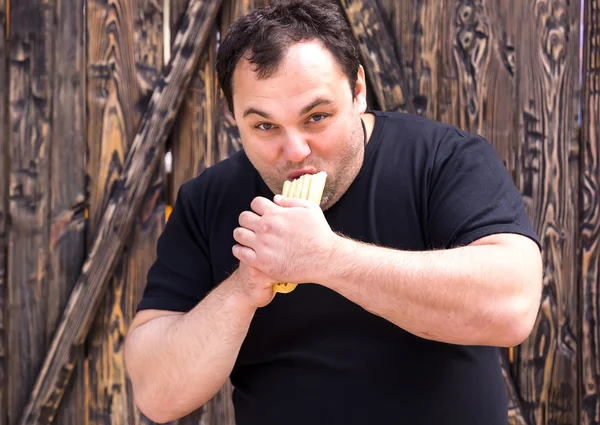 Brutal hombre comiendo un hot dog —  Fotos de Stock