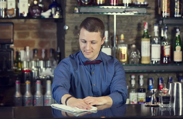 Young man working as a bartender — Stock Photo, Image