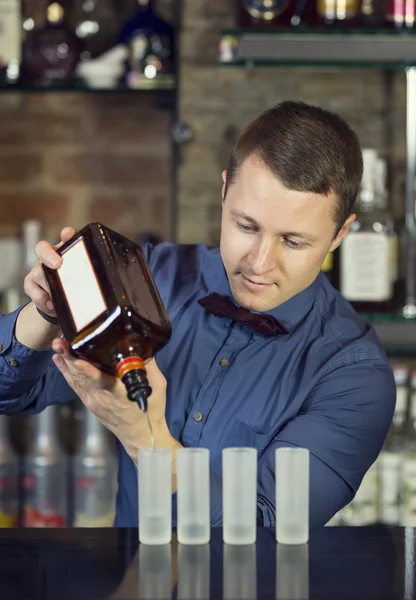 Young man working as a bartender — Stock Photo, Image