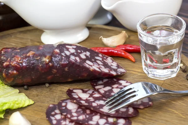 Sausages on a wooden plate — Stock Photo, Image