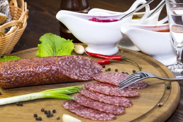 Sausages on a wooden plate — Stock Photo, Image