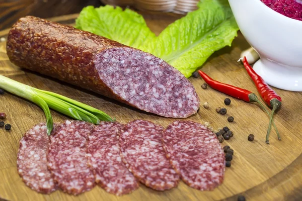 Sausages on a wooden plate — Stock Photo, Image