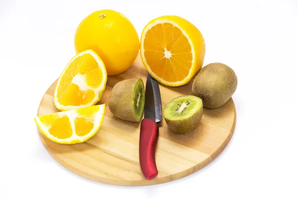 Kiwi and orange on a cutting board — Stock Photo, Image