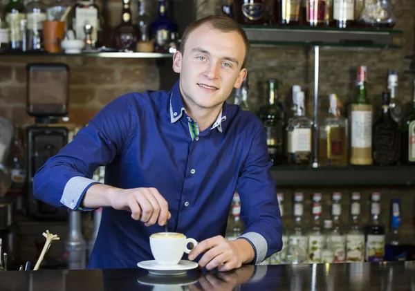 Young man working as a bartender