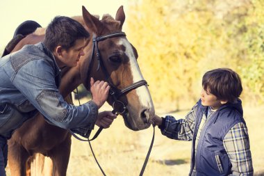 Father and son with horse clipart