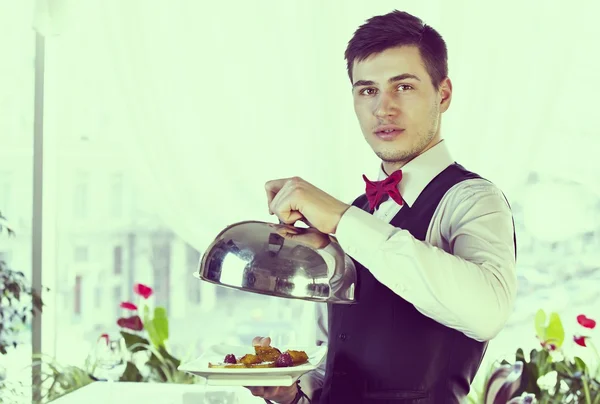 Waiter with tray of food