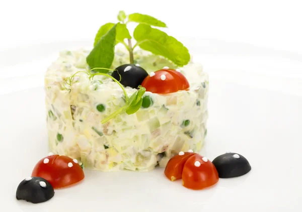 Olivier salad decorated with tomatoes — Stock Photo, Image