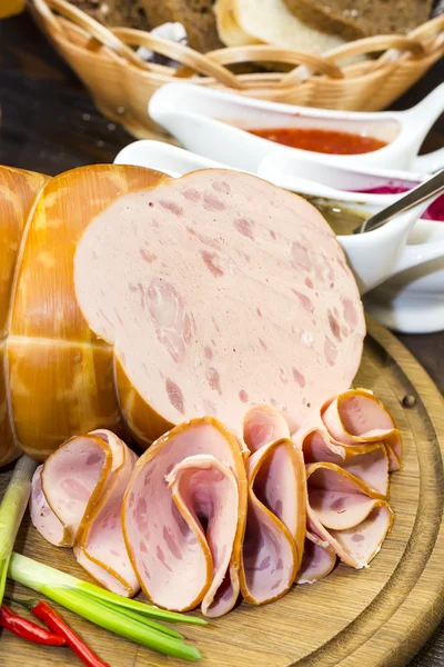 Sausage on wooden plate — Stock Photo, Image