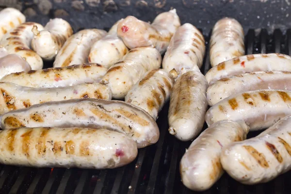 Cooking sausages on the grill — Stock Photo, Image