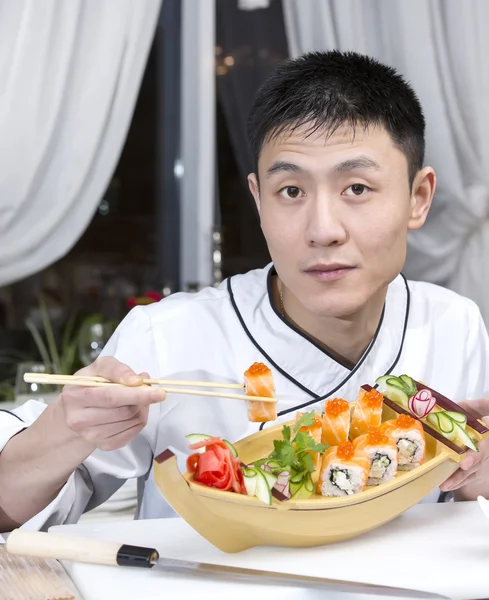 Шеф-повар показывает суши-роллы — стоковое фото