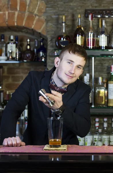 Young man working as a bartender — Stock Photo, Image