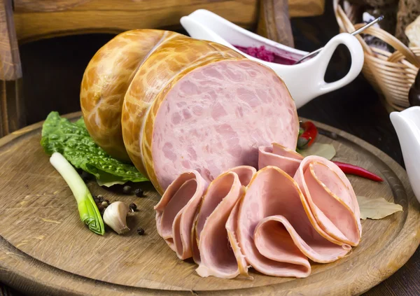 Sausage on wooden plate — Stock Photo, Image