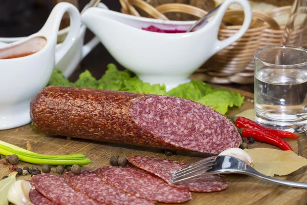 Sausage on wooden plate — Stock Photo, Image