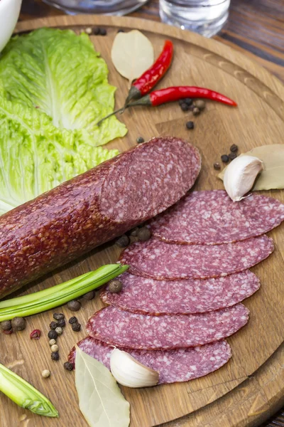 Sausage on wooden plate — Stock Photo, Image