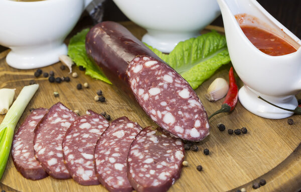 Sausage on wooden plate