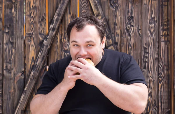 Homem comendo cachorro quente — Fotografia de Stock