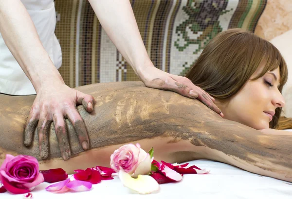 Girl doing a clay massage procedure — Stock Photo, Image