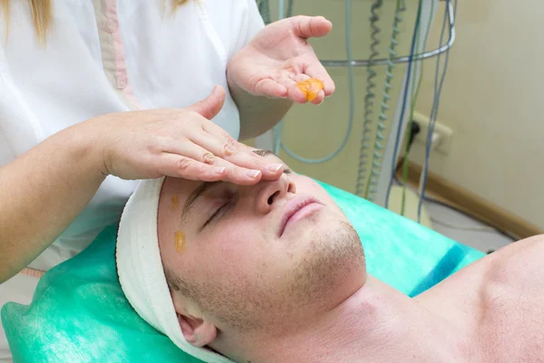 Man in the mask cosmetic procedure — Stock Photo, Image