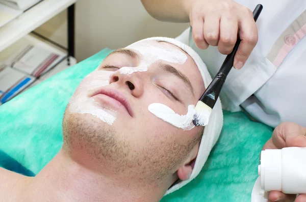 Man in the mask cosmetic procedure — Stock Photo, Image