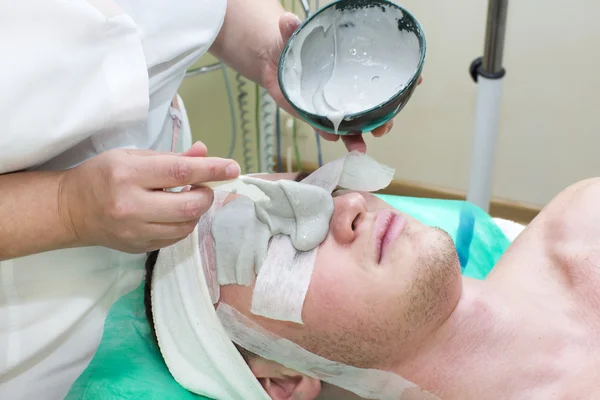 Man in the mask cosmetic procedure — Stock Photo, Image