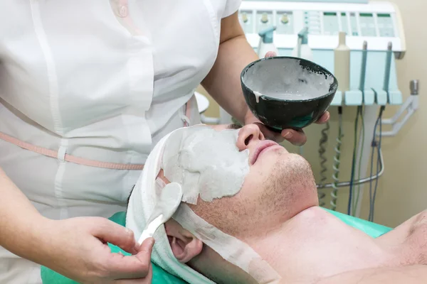 Man in the mask cosmetic procedure — Stock Photo, Image