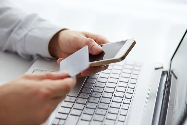 Man with mobile phone and credit card payment — Stock Photo, Image