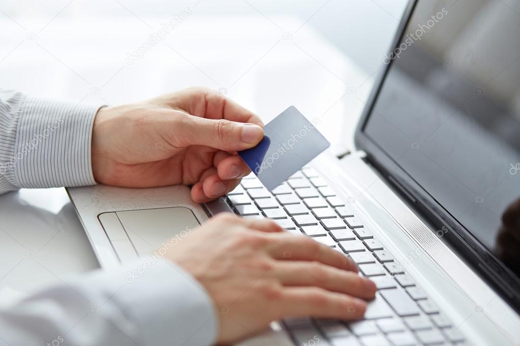 Male hands holding credit card