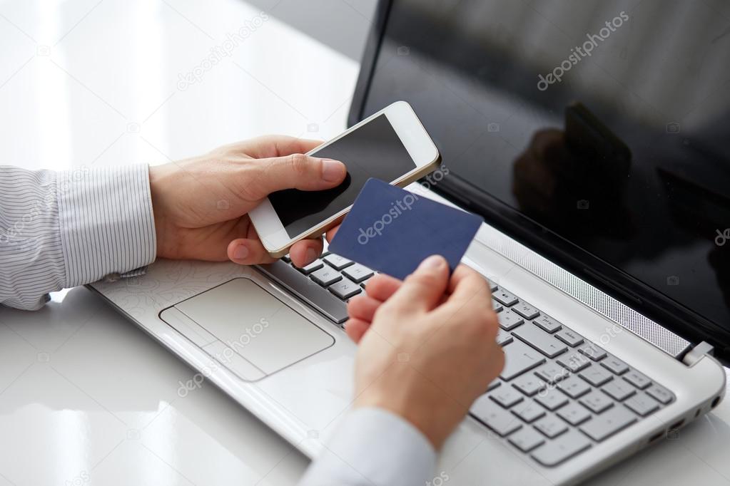 Male hand holding a mobile phone and payment