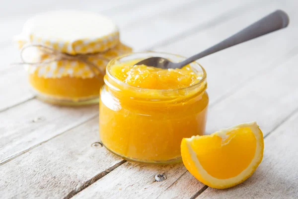 Orange marmalade on white table — Stock Photo, Image