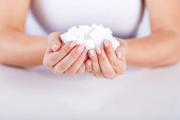 Femme tient dans les mains de cubes de sucre — Photo