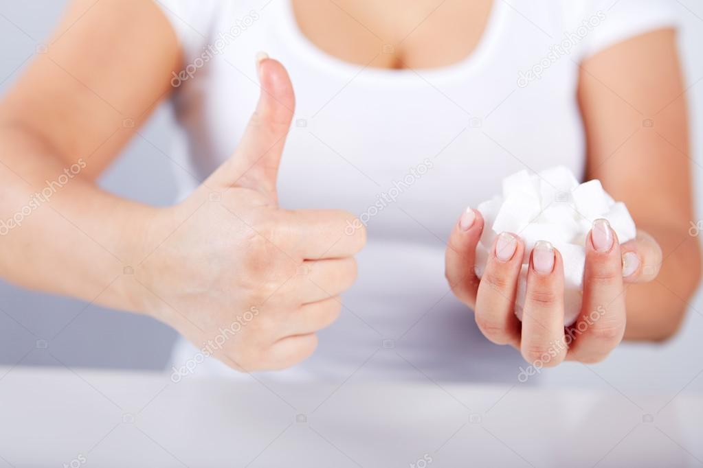 Woman holds in hand of sugar cubes