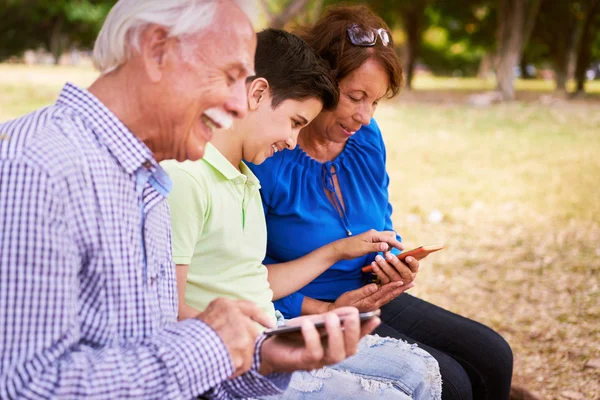 Kind helpen oma tekstoverseinen op mobiele telefoon — Stockfoto