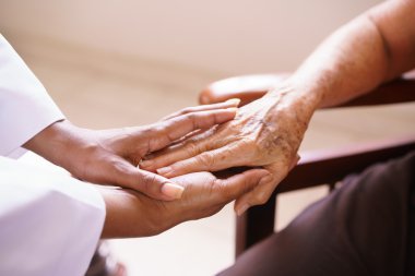 Senior Woman Talking With Black Doctor In Hospice clipart