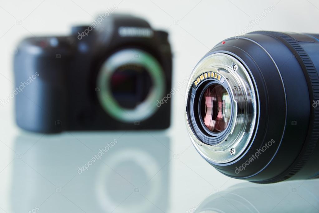 Closeup Of DSLR Photo Camera And Still Lens On Desk 